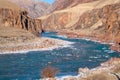 Unfrozen clear river water running through canyon in winter