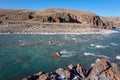 Unfrozen clear river water running through canyon in winter