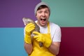 Ung male fisher with yellow apron holding a big salmon, trout fish