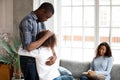Unhappy African American family in living room divorce concept