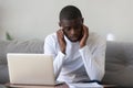 Unhappy African American man reading bad news in paper letter