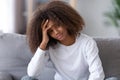 Unhappy African American teenage girl sitting alone, having problem