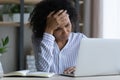 Unhappy African American woman feel tired at workplace