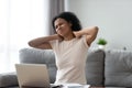 Unhappy African American woman massaging neck, suffering from pain Royalty Free Stock Photo