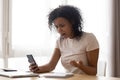 Unhappy African American woman reading bad news, problem with phone