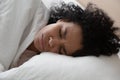 Unhappy African American woman suffering from nightmare, lying in bed