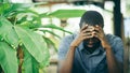 Unhappy african man having puzzled expression, holding hand on his head. Black guy stressting and headache Royalty Free Stock Photo