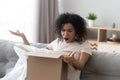 Unhappy angry African American woman client dissatisfied by parcel