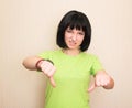 Unhappy, angry, displeased teenage girl giving thumb down hand gesture, isolated Royalty Free Stock Photo