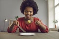 Unhappy angry screaming african american woman on diet looking at piece of apple Royalty Free Stock Photo