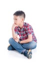 Unhappy boy sitting on the floor over white Royalty Free Stock Photo