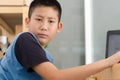 Asian boy using laptop computer at home Royalty Free Stock Photo