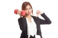 Unhappy Asian business woman thumbs down with dumbbells Royalty Free Stock Photo