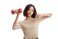 Unhappy Asian business woman thumbs down with dumbbells Royalty Free Stock Photo