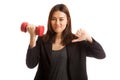 Unhappy Asian business woman thumbs down with dumbbells. Royalty Free Stock Photo