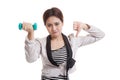 Unhappy Asian business woman thumbs down with dumbbells. Royalty Free Stock Photo