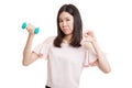 Unhappy Asian business woman thumbs down with dumbbells. Royalty Free Stock Photo