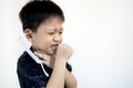 Unhappy asian child boy suffering from cough,sore throat in rainy season,respiratory tract infection,unwell kid has seasonal