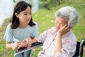 Unhappy asian child girl comfort upset offended senior grandmother,female teenager is stressed to trying to reconcile or