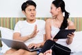 Unhappy Asian couple having issues surfing the internet Royalty Free Stock Photo