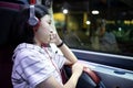 Unhappy asian schoolgirl sit in the bus alone at night,looking through the window,thinking lonely,missing family during back to Royalty Free Stock Photo