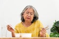 Unhappy Asian senior woman anorexia and say no to ready meals, Elderly home alone and bored food and no appetite Royalty Free Stock Photo