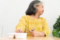 Unhappy Asian senior woman anorexia and say no to ready meals, Elderly home alone and bored food and no appetite Royalty Free Stock Photo