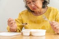 Unhappy Asian senior woman anorexia and say no to ready meals, Elderly home alone and bored food and no appetite Royalty Free Stock Photo