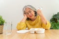 Unhappy Asian senior woman anorexia and say no to ready meals, Elderly home alone and bored food and no appetite Royalty Free Stock Photo