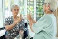 Unhappy asian senior woman rejecting,gesture hand NO ,tired old people feeling sick,dysphagia,dyspepsia or bored of food,friend Royalty Free Stock Photo