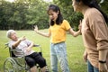 Unhappy asian teen granddaughter dissuade her family from a fight something money,angry senior mother and daughter arguing Royalty Free Stock Photo