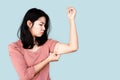 Unhappy Asian woman hand holding her fat upper arm with worried face Royalty Free Stock Photo