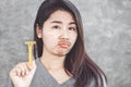 Unhappy Asian woman having problem with mustache growing on face ,hand holding razor