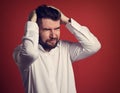 Unhappy bearded business man holding the head the hands with closed eyes in white shirt on red background. portrait of stress. Cl Royalty Free Stock Photo