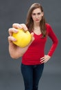 Unhappy beautiful young woman with apple for focus on pesticides