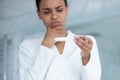 Unhappy biracial woman do ovulation pregnancy test