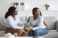 Unhappy black female patient with nervous breakdown consulting psychotherapist, having session with counselor at office Royalty Free Stock Photo