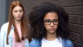 Unhappy black female teenager eyeglasses, adolescence difficulties, depression