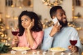 Unhappy Black Woman Bored On Date, Man Talking On Phone Royalty Free Stock Photo