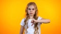 Unhappy blond girl making thumbs-down gesture, dislike services, poor quality