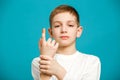 Unhappy boy with adhesive plaster on his thumb