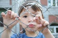 Unhappy boy behind bars Royalty Free Stock Photo