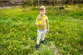 Unhappy boy with a bouquet of dandelions Royalty Free Stock Photo