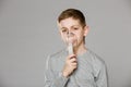 Unhappy boy breathing through inhalator mask