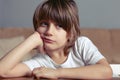 Unhappy boy sits at the desk Royalty Free Stock Photo