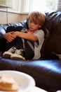 Unhappy Boy Sitting On Sofa At Home Royalty Free Stock Photo