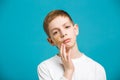 Unhappy boy in white with adhesive plaster on his cheek Royalty Free Stock Photo