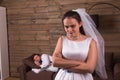 Unhappy bride, sleeping groom on background Royalty Free Stock Photo