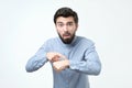 Unhappy business man in blue shirt lost his watch Royalty Free Stock Photo