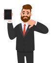 Unhappy business man showing/holding blank screen of new digital tablet computer and gesturing, making, showing thumbs down sign. Royalty Free Stock Photo